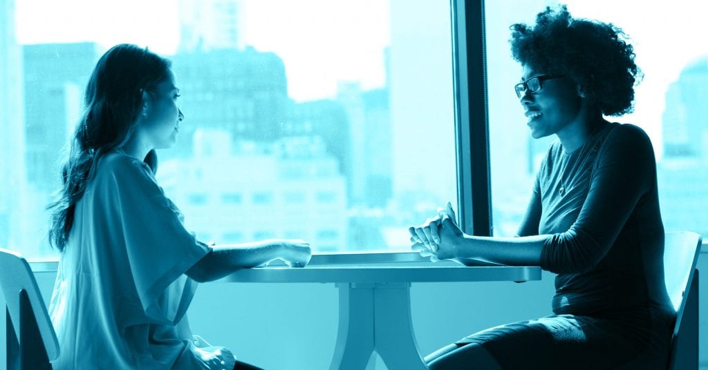 two people sitting at table